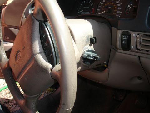 1995 Ford Taurus - The interior of a 1995 Ford Taurus, the steering wheel, dashboard gauges, and ignition switch.
