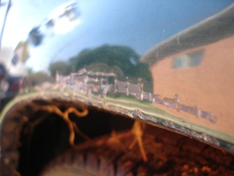 1995 Ford Taurus - Rust is visible along the lower edge of the car's fender, indicating body damage.