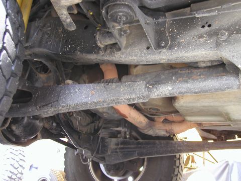 1984 Ford Bronco - Underside view of a vehicle's chassis and exhaust system, with a Supermotors.net watermark.