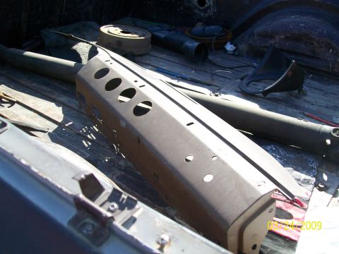 1972 Ford Ranchero - Various automotive parts are stored in the bed of a pickup truck.