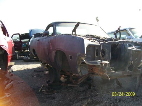 1972 Ford Ranchero - A 1972 Ford Ranchero sits in a junkyard, stripped of many of its parts.