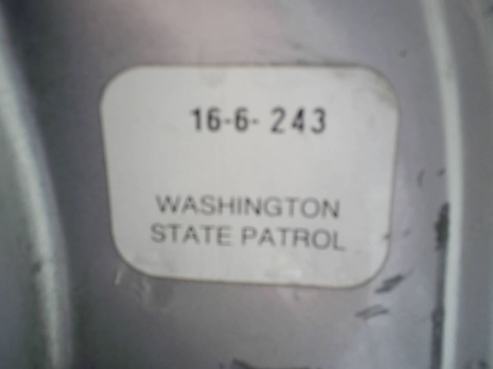 White Washington State Patrol label marked 16-6-243 on a gray metal surface.