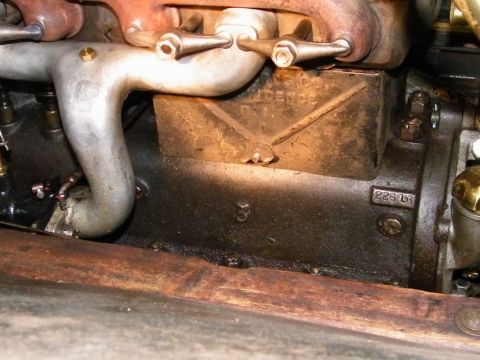 1909 Ford Model T - Close-up view of an engine block showing casting marks and numbers, not definitively a 1909 Ford Model T.