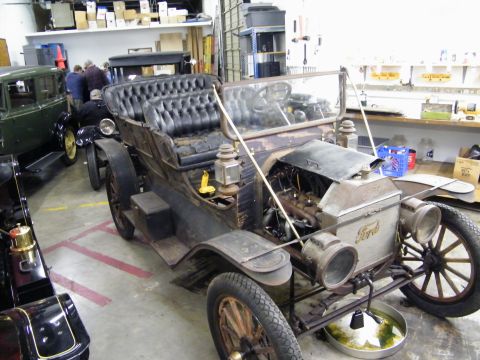 1909 Ford Model T - This 1909 Ford Model T touring car is shown with its engine exposed and features a distinctive tufted interior.