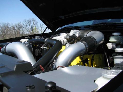 2003 Mercury Marauder - Close-up of a modified engine bay, showing prominent intake piping and hoses.