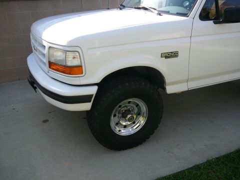 1988 Ford Bronco - Front quarter view of a white Ford Bronco, its distinctive grille and headlights.