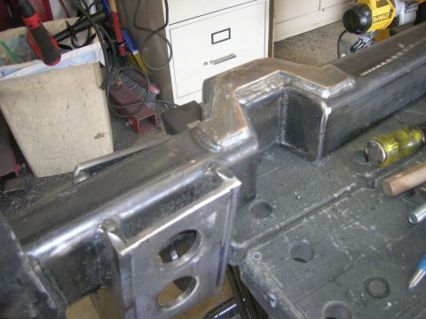 1996 Ford Bronco - Close-up of a custom-fabricated steel frame part with visible welds.