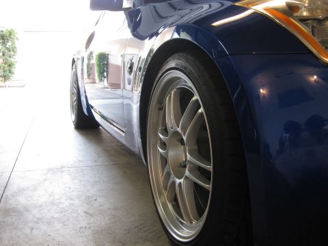 1990 Ford Probe - Close-up of a blue car's front wheel and fender, showing aftermarket wheels and a low profile tire.