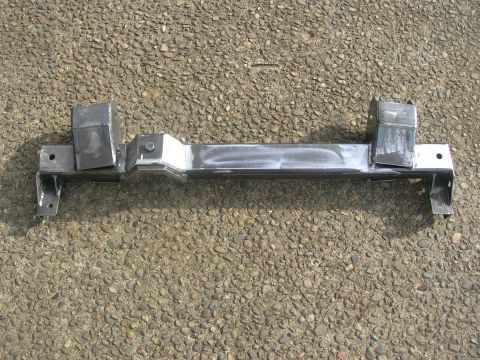 1996 Ford Bronco - Unidentified metal suspension component, likely a crossmember, shown from above against a gravel background.
