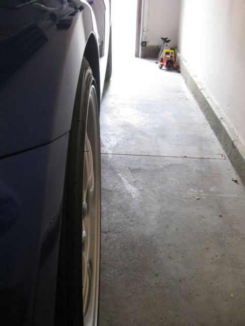 1990 Ford Probe - A car is parked in a narrow garage, showing its side profile and wheel.