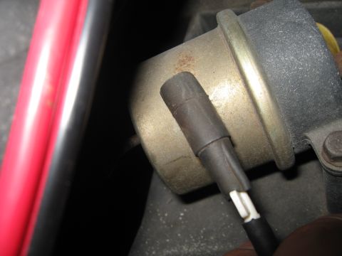1994 Ford Bronco - Close-up view of a vacuum hose attached to a metal canister, with "SUPERMOTORS.NET" visible at the bottom.