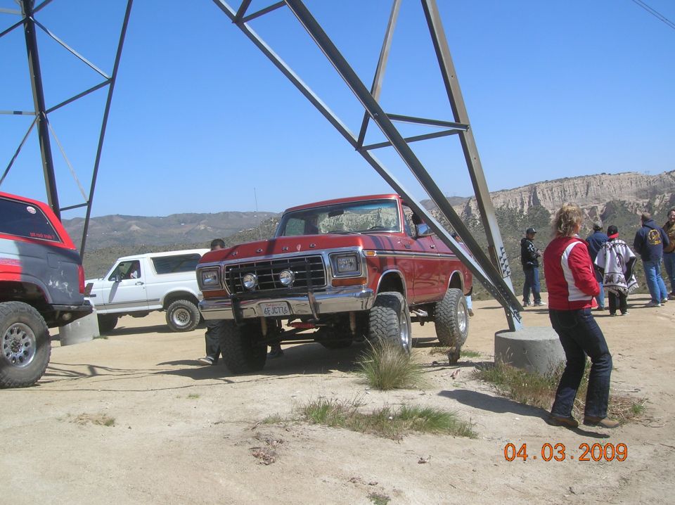 Red lifted 1979 Ford truck with chrome grille and aftermarket lights