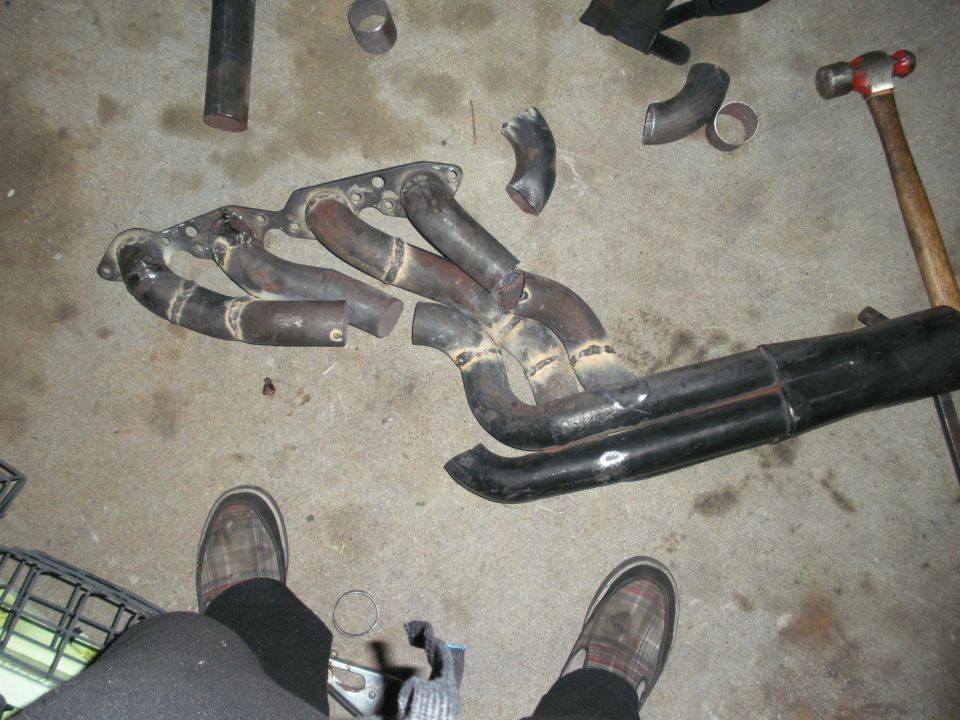 Exhaust manifold and pipes on concrete floor