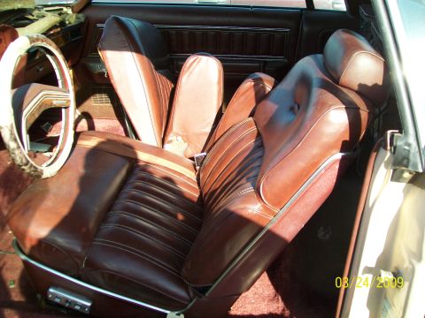 1972 Ford Ranchero - The interior of a 1972 Ford Ranchero shows brown leather seats and a dated steering wheel.