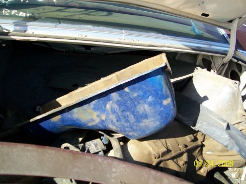 1972 Ford Ranchero - The trunk of a vehicle contains a blue plastic bin and other assorted parts, with the word "BRAT" scrawled on the upper edge.