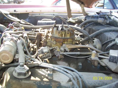 1972 Ford Ranchero - Close-up view of a vehicle's engine bay, focusing on the carburetor and associated components.