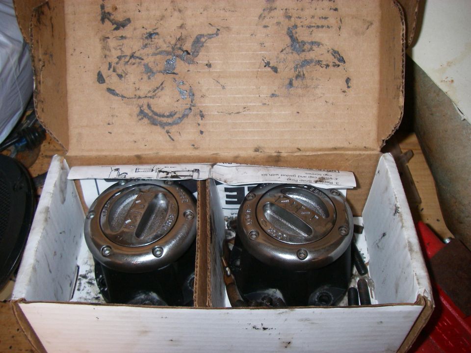 Two aftermarket manual locking hubs in a cardboard box with instructions