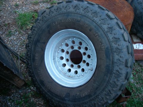 1978 Ford Bronco - Close-up of a Super Swamper Radial TSL tire mounted on a polished aluminum wheel.