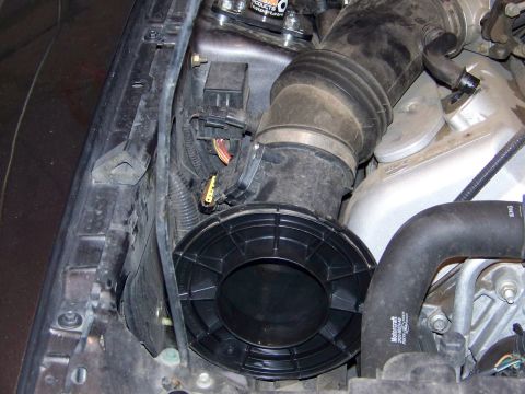 1993 Ford Bronco - Close-up view of the engine's air intake system with various hoses and electrical connectors.