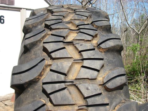 1978 Ford Bronco - The aggressive tread pattern of a large off-road tire is shown in detail.