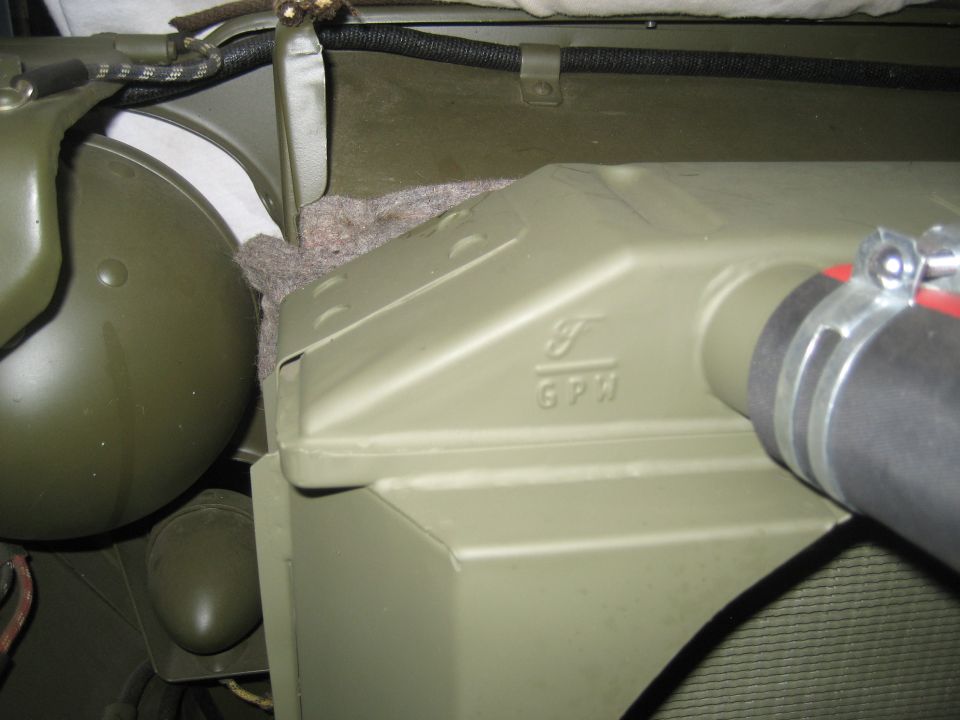 Green metal component with F GPH text and hose