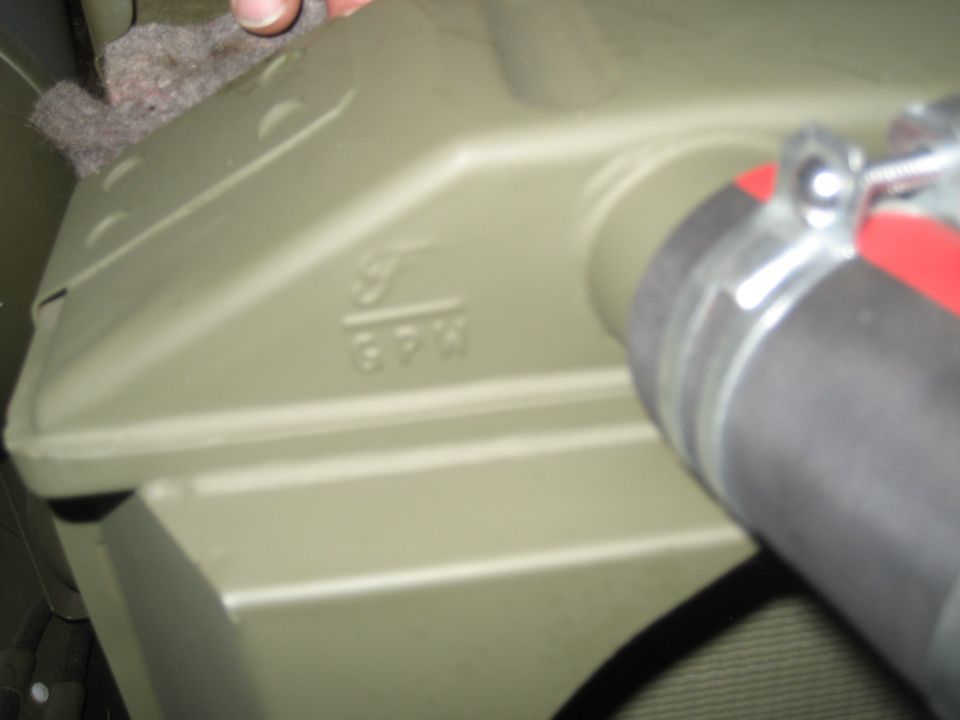 Green metal housing with embossed text GPW M49 and a hose clamp.