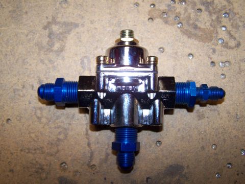 1978 Ford Bronco - this is my regulator. 1 in and 2 outs. I'm using 1 of the outs for my gauge, it uses the 4AN fitting on the right