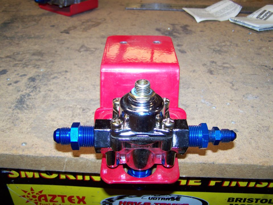 I'm planning on mounting my pump on the crossmember in front of the gas tank. Then my plan is: 

hose from tank to "in" on pump

out of pump to "in" on filter, mounted on driver side frame rail

out of filter to "in" on regulator, mounted on bottom of cowl, beside M/C

1 hose out of reg. to carb inlet, which will be at the rear of carb

1 hose,4AN, out of reg. to the gauge, mounted on cowl, in front of driver
