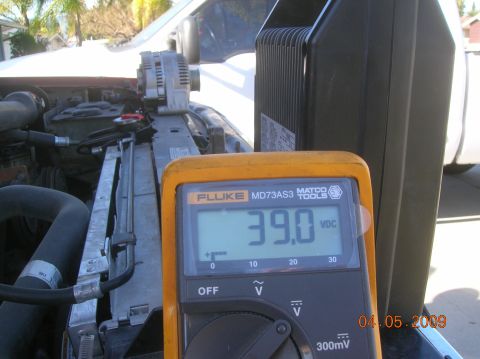 1985 Ford Bronco - A Fluke MD73AS3 multimeter displays 39.0 VDC next to a vehicle's alternator and radiator in an outdoor setting. The date stamp on the image…