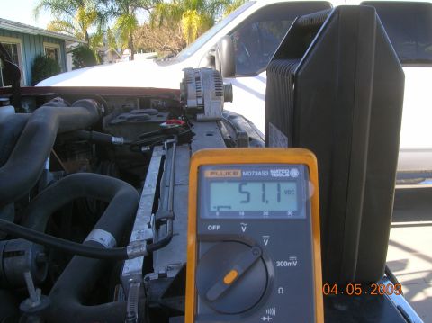 1985 Ford Bronco - A Fluke MD73AS3 multimeter displays 51.1 VDC next to the alternator of a vehicle's engine bay. The engine bay appears to be from a truck or…