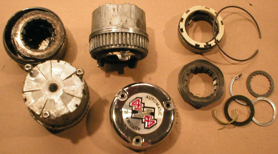 Disassembled automatic locking hub components laid out on a table
