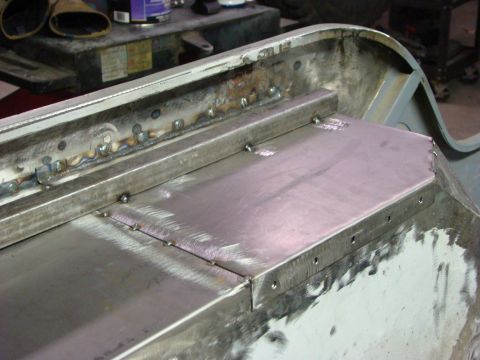 1948 Jeep Wrangler - Close-up view of metal panel repair with visible welding and drilled holes.