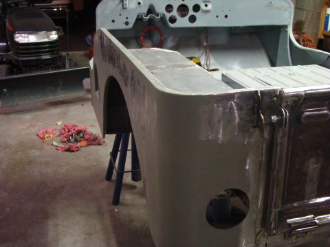 1948 Jeep Wrangler - The rear quarter panel and tailgate of a Jeep CJ-2A are shown during a restoration. The vehicle is supported by jack stands and appears to…