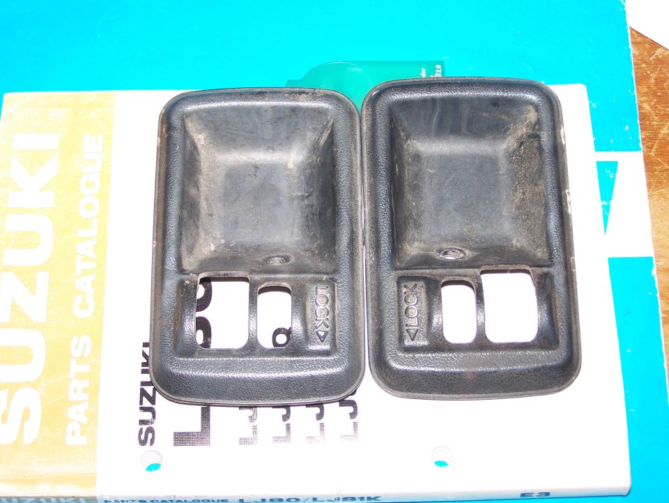 Two black Suzuki Samurai interior door handles on a Suzuki Parts Catalogue.