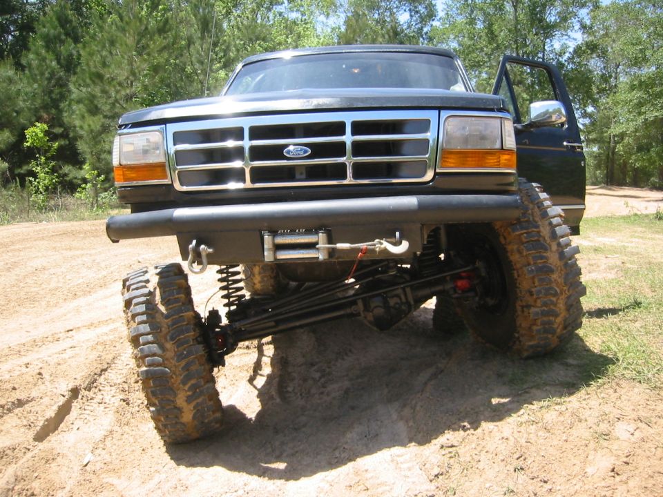 Black lifted 1995 Ford Bronco front view with off-road tires and winch