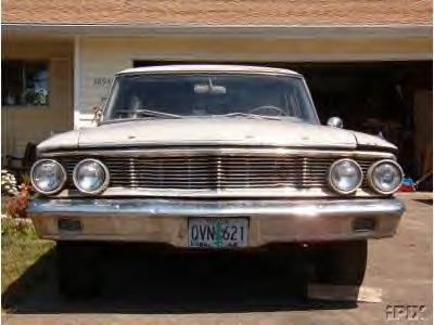 1964 Ford Custom Wagon - Front view of a 1964 Ford Custom Wagon parked in front of a garage.