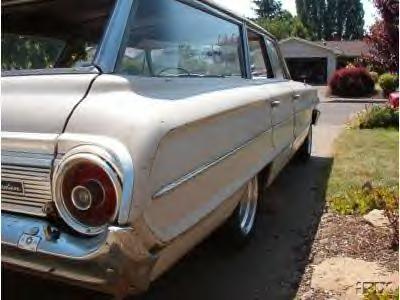 1964 Ford Custom Wagon - This 1964 Ford Custom Wagon is seen from the rear quarter angle, parked in front of a suburban house.