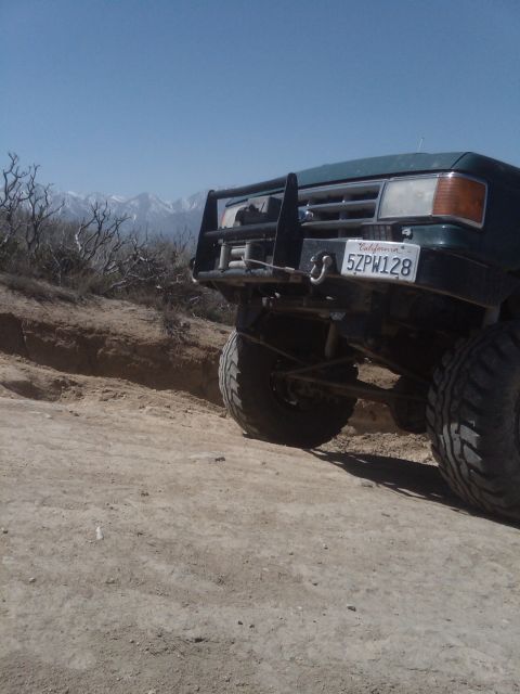 1982 Ford Bronco - This vehicle is on a dirt trail with mountains in the distance.