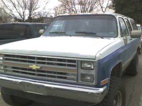 1988 Chevrolet Suburban - This 1988 Chevrolet Suburban is shown from the front three-quarter view, with a two-tone paint scheme.