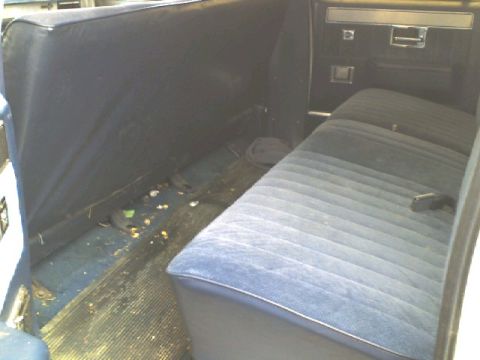 1988 Chevrolet Suburban - Rear bench seat and door panel visible inside a 1988 Chevrolet Suburban.