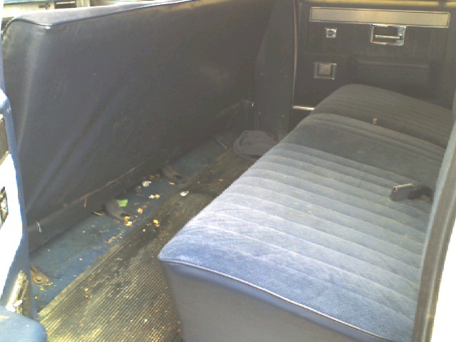 1988 Chevrolet Suburban interior showing blue striped rear bench seat and door panel