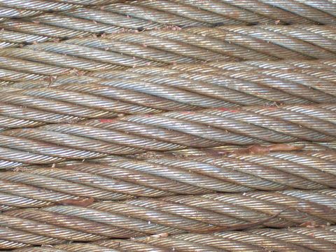 1990 Ford Bronco - Close-up of a steel cable, showing its braided construction and some red markings. The SuperMotors.net logo is visible in the lower right c…