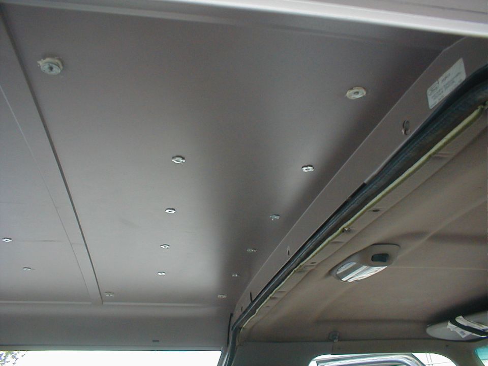 Some of the nuts have to be spaced down or shortened because the roof is so thin.  Although silicone helps hold the nuts while screws are being installed, the first camper I did this to had none and never leaked.  Using the shortest screws available (~1/2") allows a stock '92-96 headliner to fit.