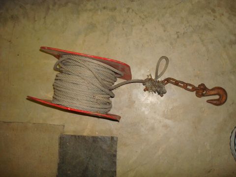 1995 Ford Bronco - A winch cable is shown wound on a spool, attached to a chain and hook.