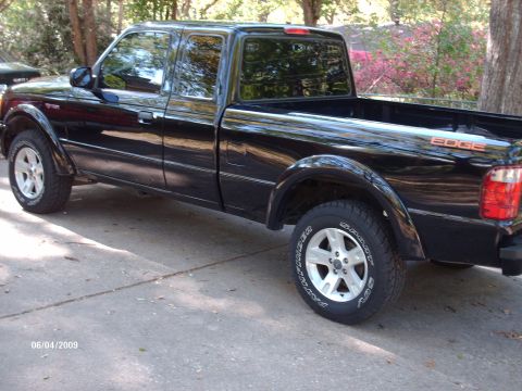 1990 Ford F-150 - A black pickup truck is shown from the side, 'EDGE' badging on the rear tailgate.