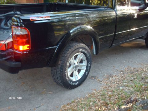 1990 Ford F-150 - Rear view of a black pickup truck, showing the EDGE decal on the bed and custom wheels.