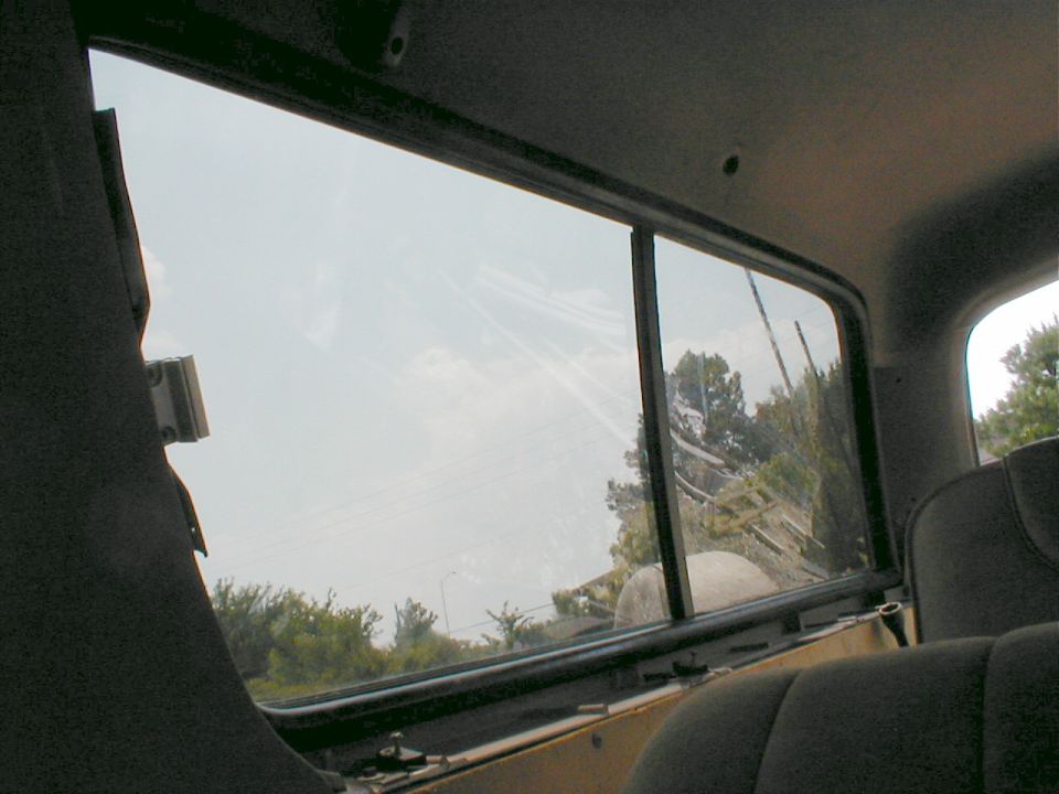 Pounding on the glass along the edges will let the gaskets settle into place. The edges of the headliner go behind the gaskets.