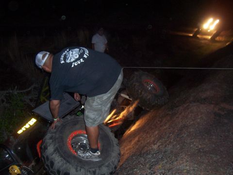 2004 Aston Martin Virage - Off-road vehicles stuck on rocky terrain at night with assistance.