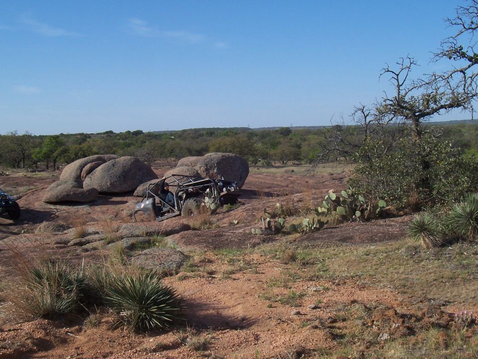 Off-road buggy stuck between rocks on a sunny day