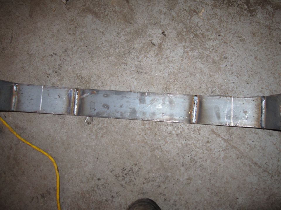Photo of a fabricated metal axle truss or bracket on a shop floor